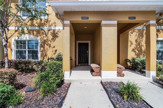8947 Bismarck Palm Rd, Kissimmee, FL 34747 - entrance to property featuring stucco siding
