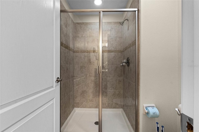 bathroom featuring a shower with door