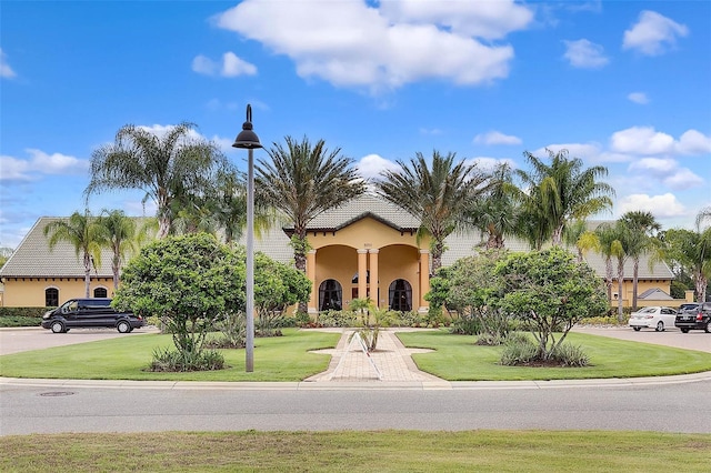 8947 Bismarck Palm Rd, Kissimmee, FL 34747 - mediterranean / spanish house with stucco siding and a front lawn