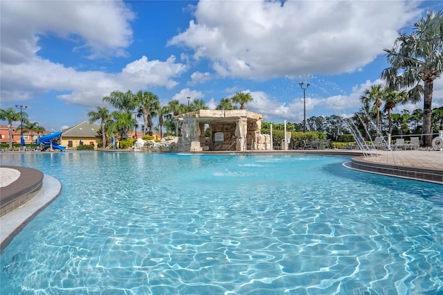 view of swimming pool with pool water feature