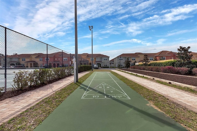 8947 Bismarck Palm Rd, Kissimmee, FL 34747 - view of property's community featuring shuffleboard, fence, and a residential view