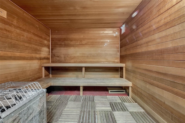 view of sauna with wood walls and wooden ceiling