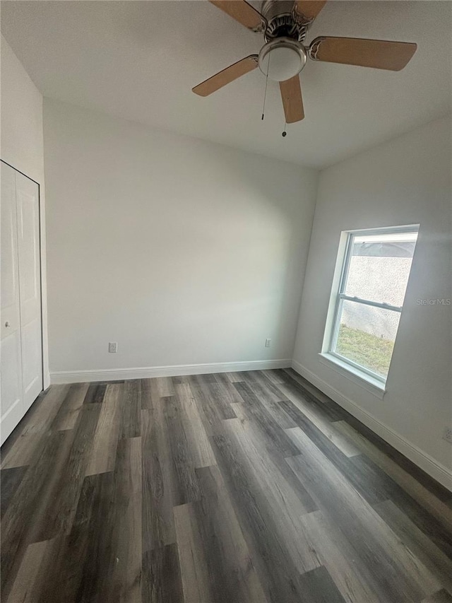 spare room with dark hardwood / wood-style flooring