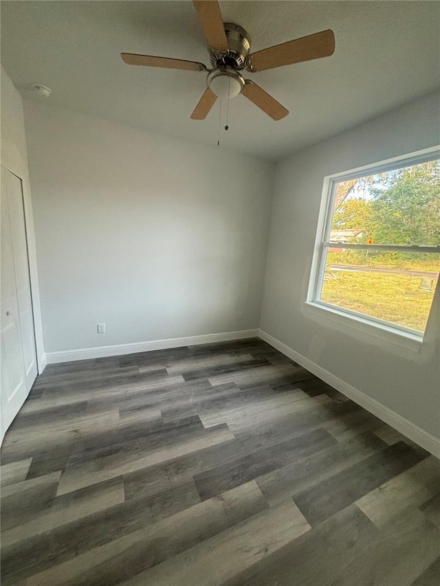 empty room featuring ceiling fan and dark wood-type flooring