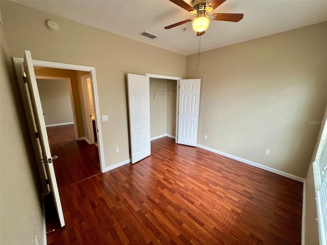 unfurnished bedroom with ceiling fan, a closet, and dark hardwood / wood-style flooring