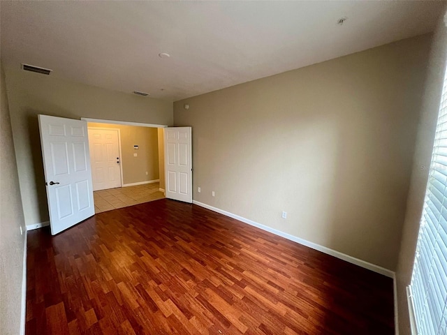 unfurnished bedroom with wood-type flooring