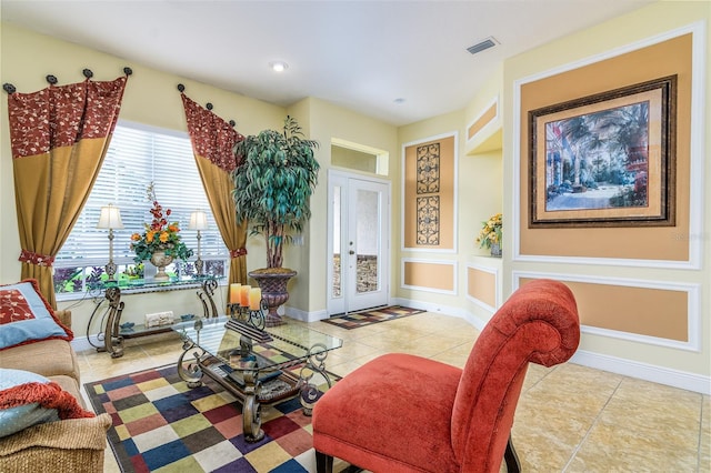 living room featuring french doors and light tile patterned floors