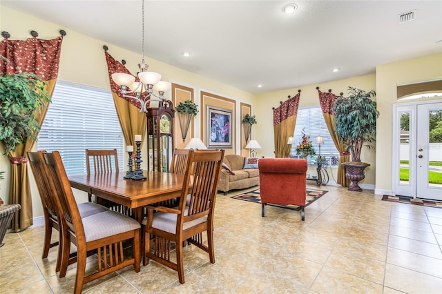 dining room featuring a notable chandelier and light tile patterned floors