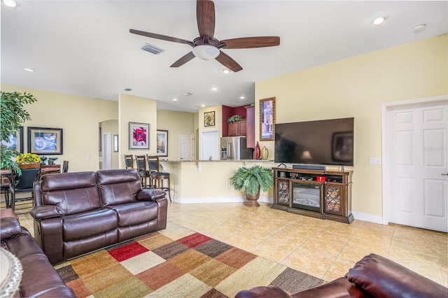 living room with light tile patterned floors and ceiling fan