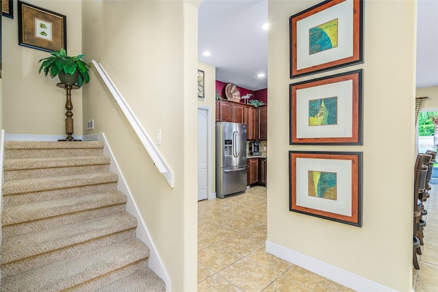 stairway with tile patterned flooring