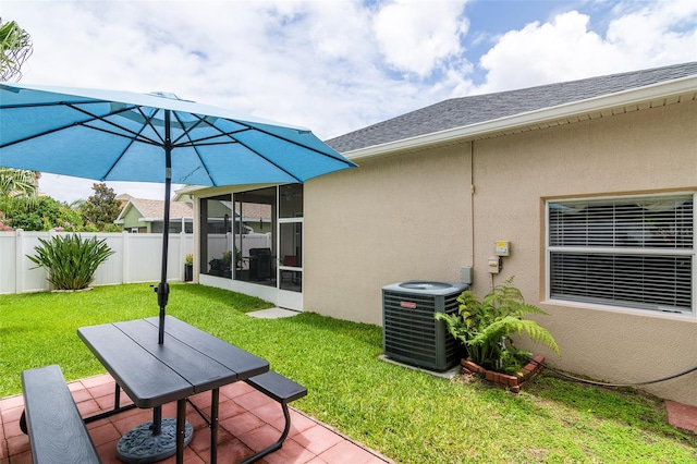 view of patio featuring cooling unit and a sunroom