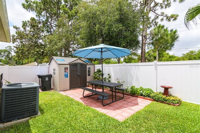 view of yard with central air condition unit, a patio, and a storage shed