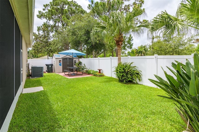 view of yard featuring central air condition unit and a patio