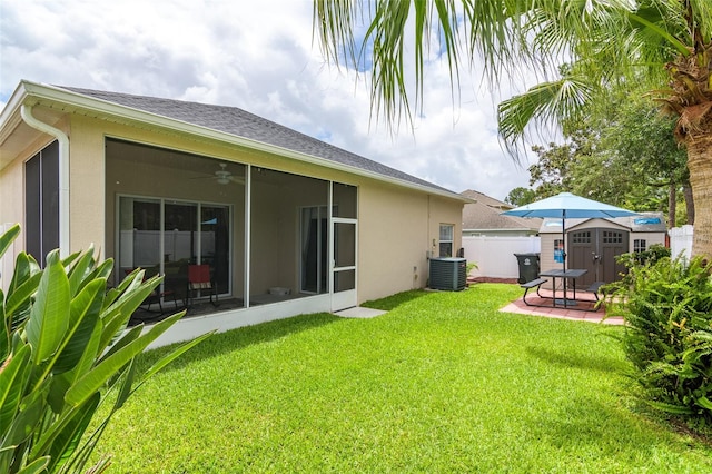 back of property featuring ceiling fan, a lawn, a patio, and central AC unit