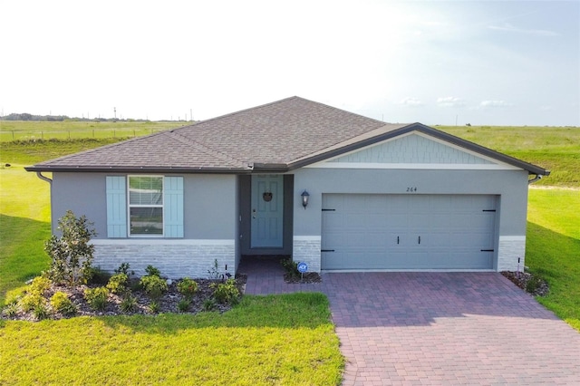 single story home featuring a garage and a front yard