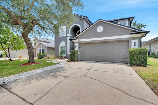 front of property with a garage and a front yard