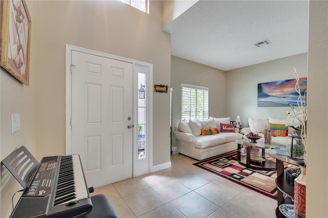 tiled foyer entrance with a textured ceiling