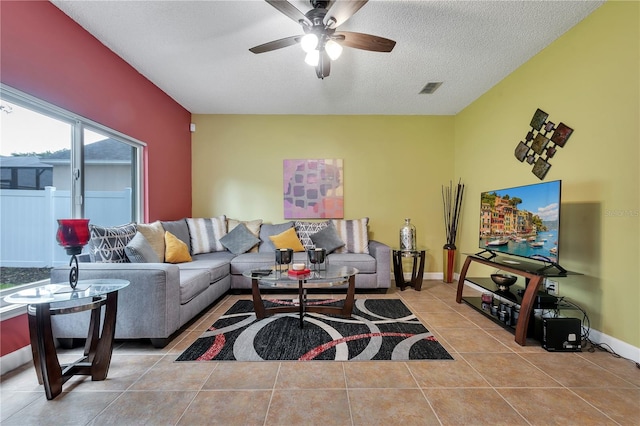 tiled living room with ceiling fan and a textured ceiling