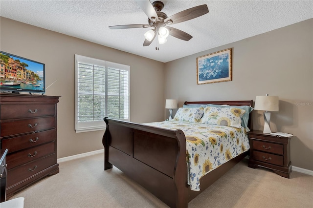 carpeted bedroom with a textured ceiling and ceiling fan