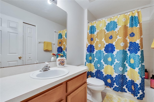 bathroom featuring walk in shower, vanity, toilet, and tile patterned floors