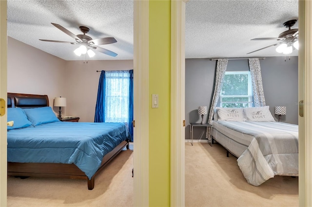 carpeted bedroom featuring multiple windows, a textured ceiling, and ceiling fan