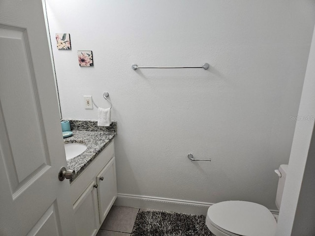 bathroom featuring vanity, toilet, and tile patterned floors