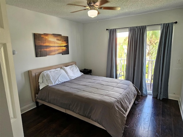 bedroom featuring ceiling fan, dark hardwood / wood-style floors, access to outside, and a textured ceiling