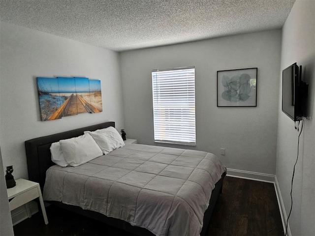 bedroom with hardwood / wood-style flooring and a textured ceiling