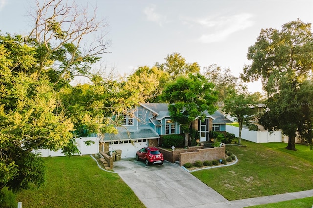 view of front of home with a front yard and a garage