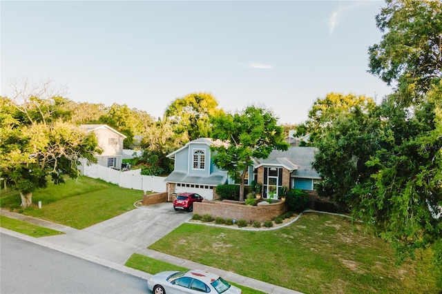 view of front of home with a garage and a front lawn