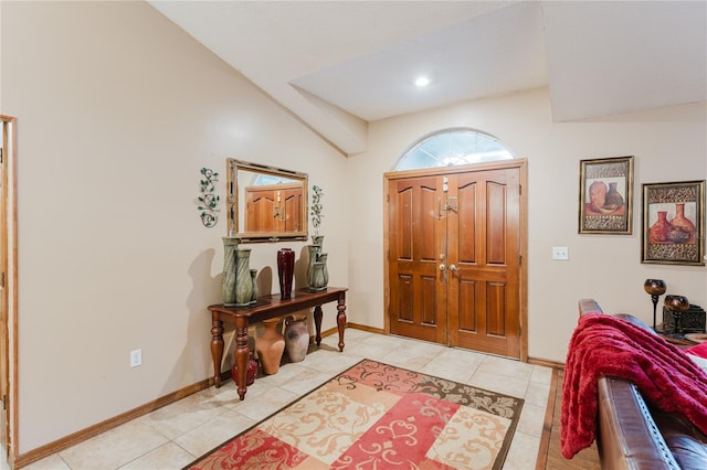 foyer featuring lofted ceiling and light tile patterned floors