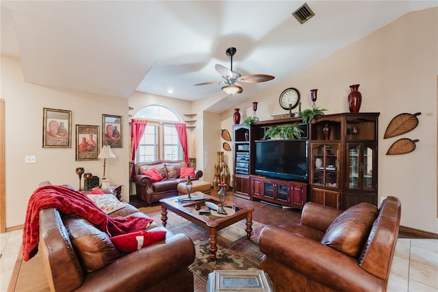 tiled living room featuring ceiling fan and vaulted ceiling