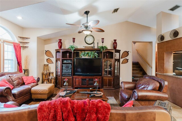 living room featuring wood-type flooring, vaulted ceiling, and ceiling fan