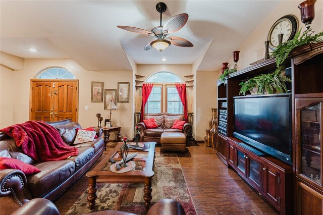 living room featuring ceiling fan and dark hardwood / wood-style floors