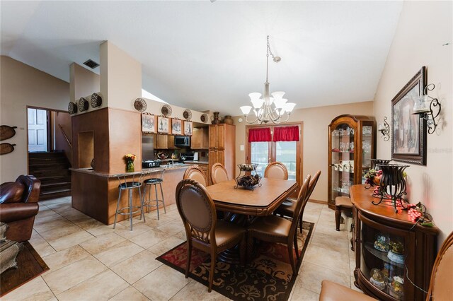 dining space featuring lofted ceiling, a chandelier, and light tile patterned flooring