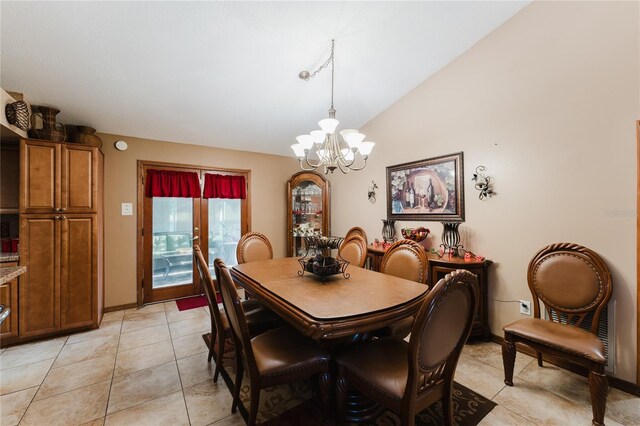 tiled dining room featuring lofted ceiling and a chandelier