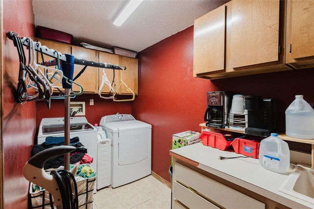 washroom featuring cabinets, a textured ceiling, independent washer and dryer, and light tile patterned flooring