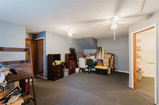 interior space featuring dark colored carpet, ceiling fan, and a textured ceiling