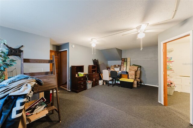 bedroom with ceiling fan, a textured ceiling, and dark colored carpet