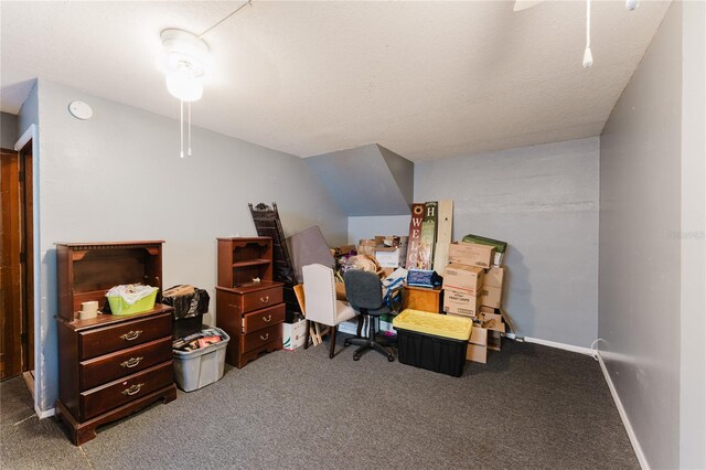 carpeted home office featuring ceiling fan and a textured ceiling