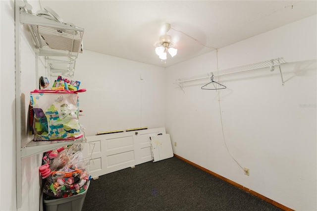 spacious closet featuring dark colored carpet