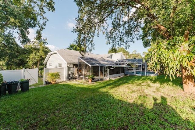 back of house featuring a yard, a pool, and glass enclosure