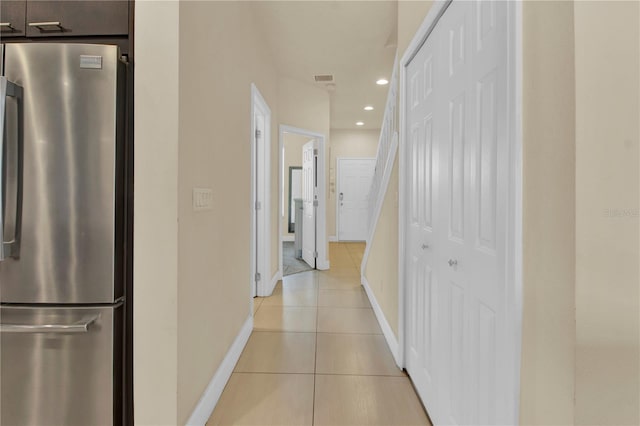 corridor featuring light tile patterned floors