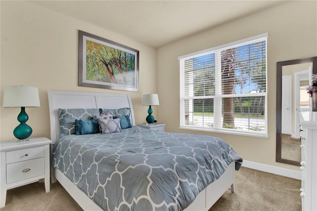 carpeted bedroom featuring multiple windows