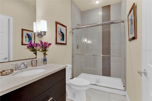 bathroom with vanity, toilet, an enclosed shower, and tile patterned floors