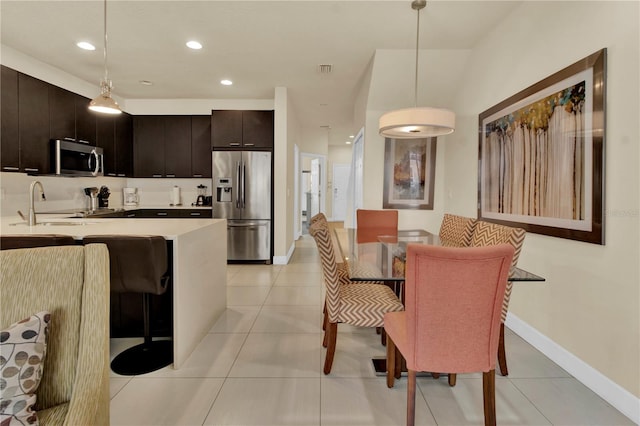 tiled dining room with sink