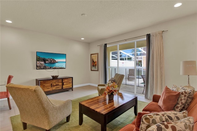 tiled living room featuring a textured ceiling