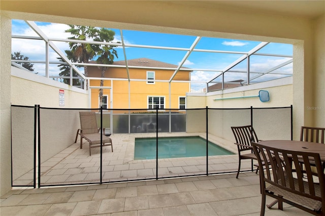 view of pool featuring a patio and glass enclosure