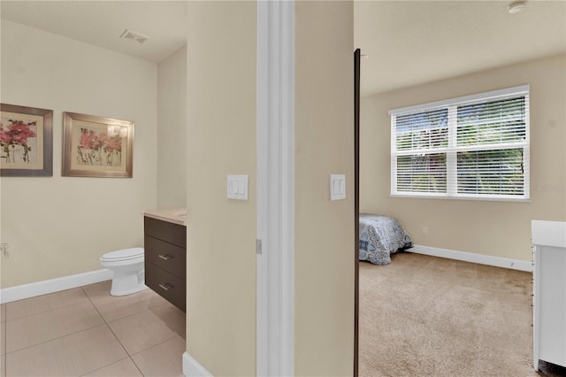 bathroom with vanity, tile patterned flooring, and toilet