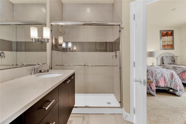 bathroom with tile patterned flooring, a shower with door, and vanity